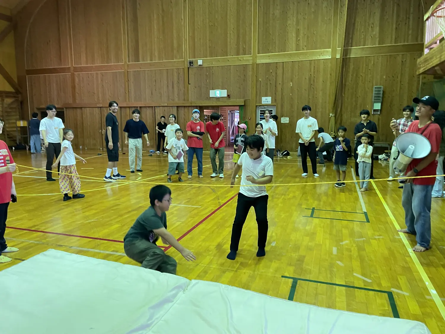 体験ブース — せかいのこども遊びラボの輪ゴム跳びに挑戦する子どもたち。